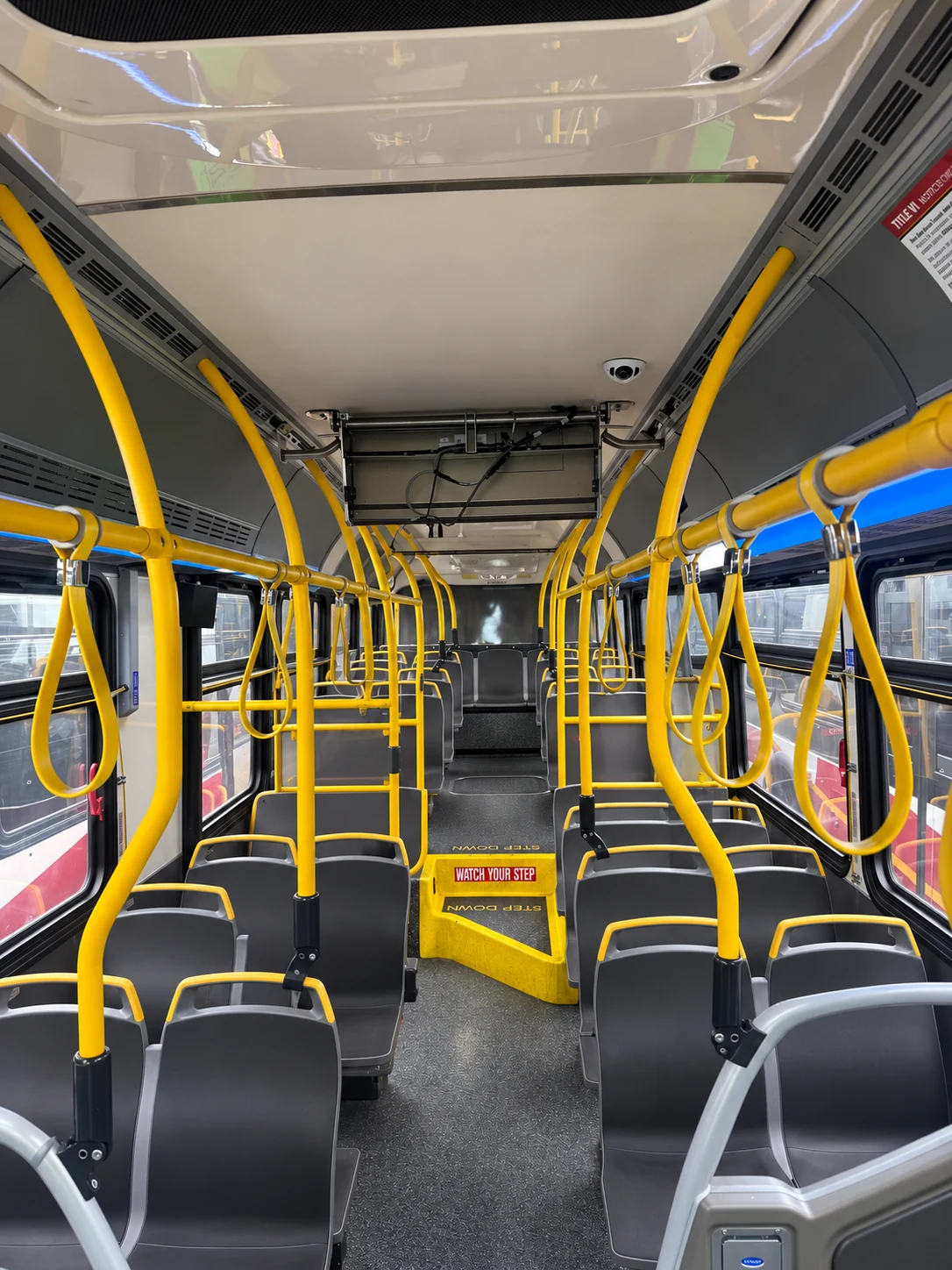 Bus interior with installed camera and open equipment panel