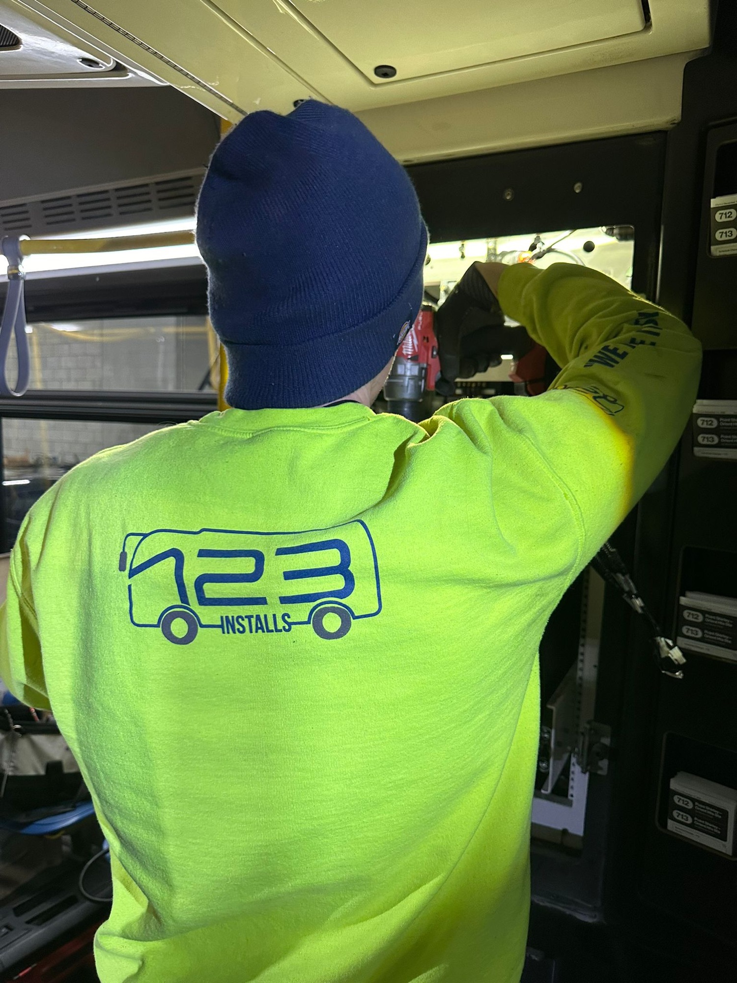 123 Installs technician working inside a bus