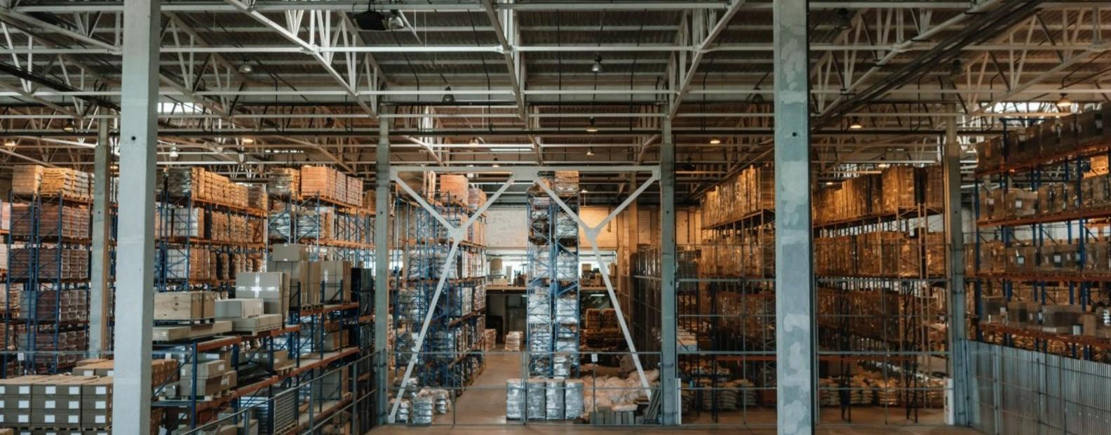 Warehouse shelving with stored equipment and packed goods.